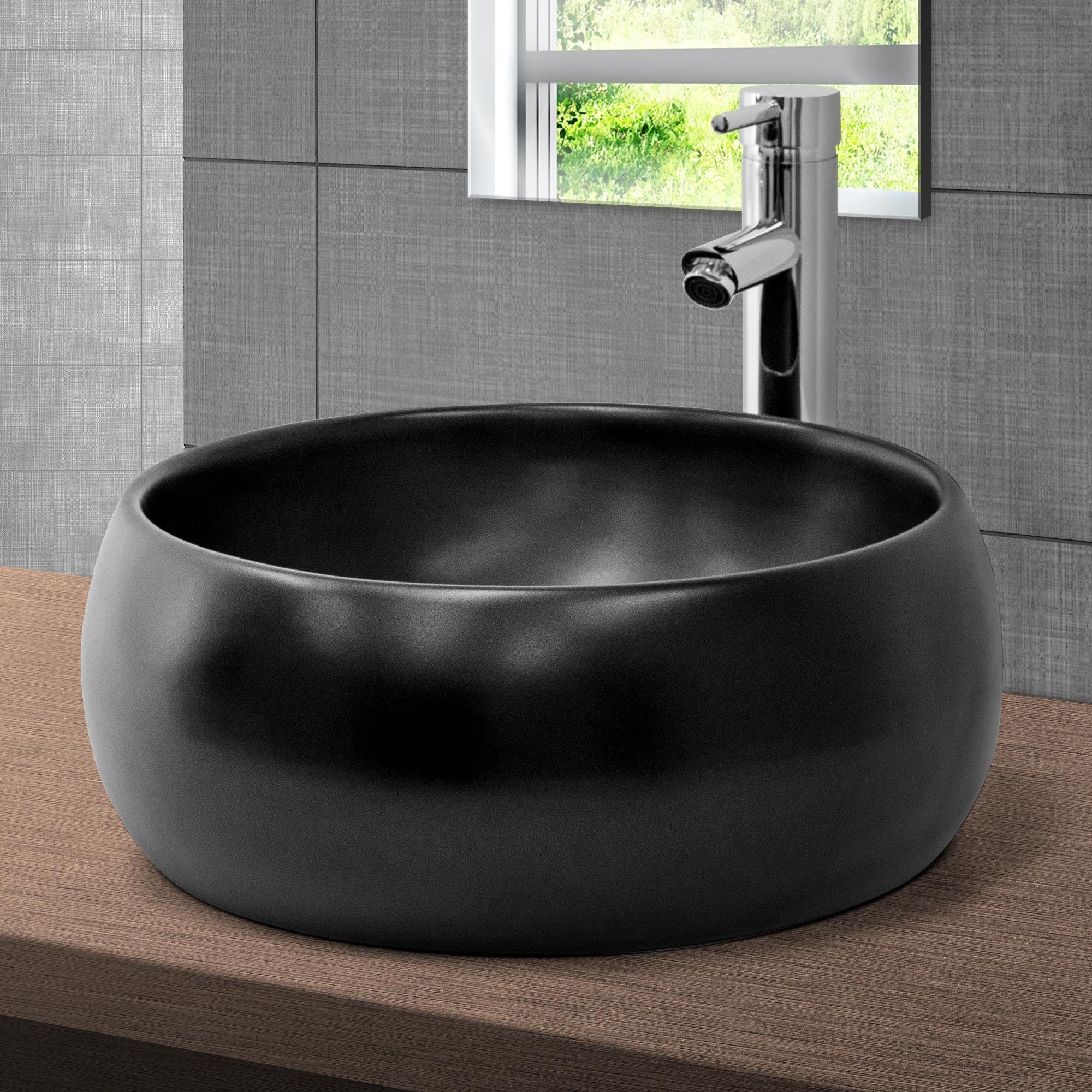 Lavabo rond noir sur un support en bois avec un robinet.
