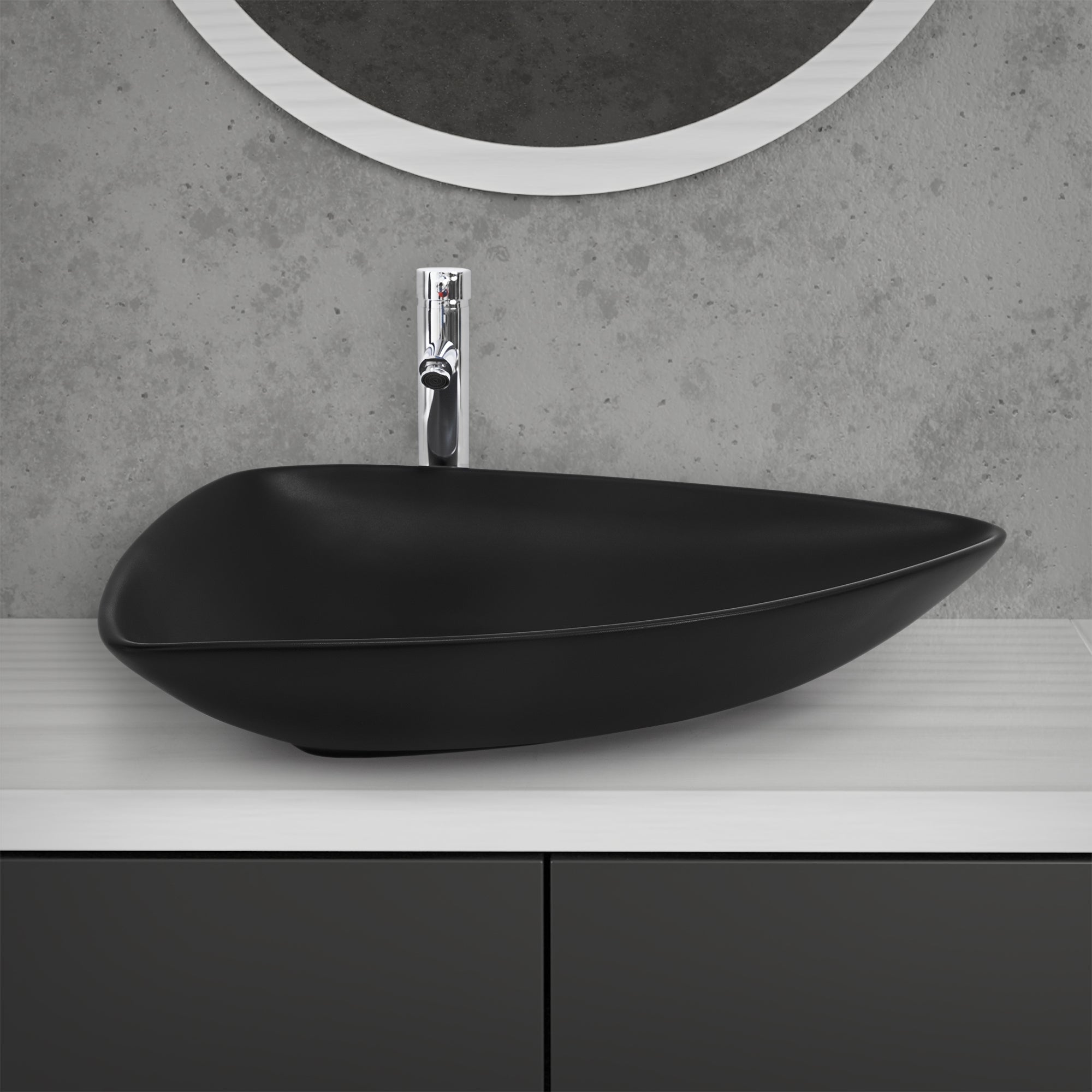 Cuenco de lavabo negro y ovalado sobre una mesa blanca.