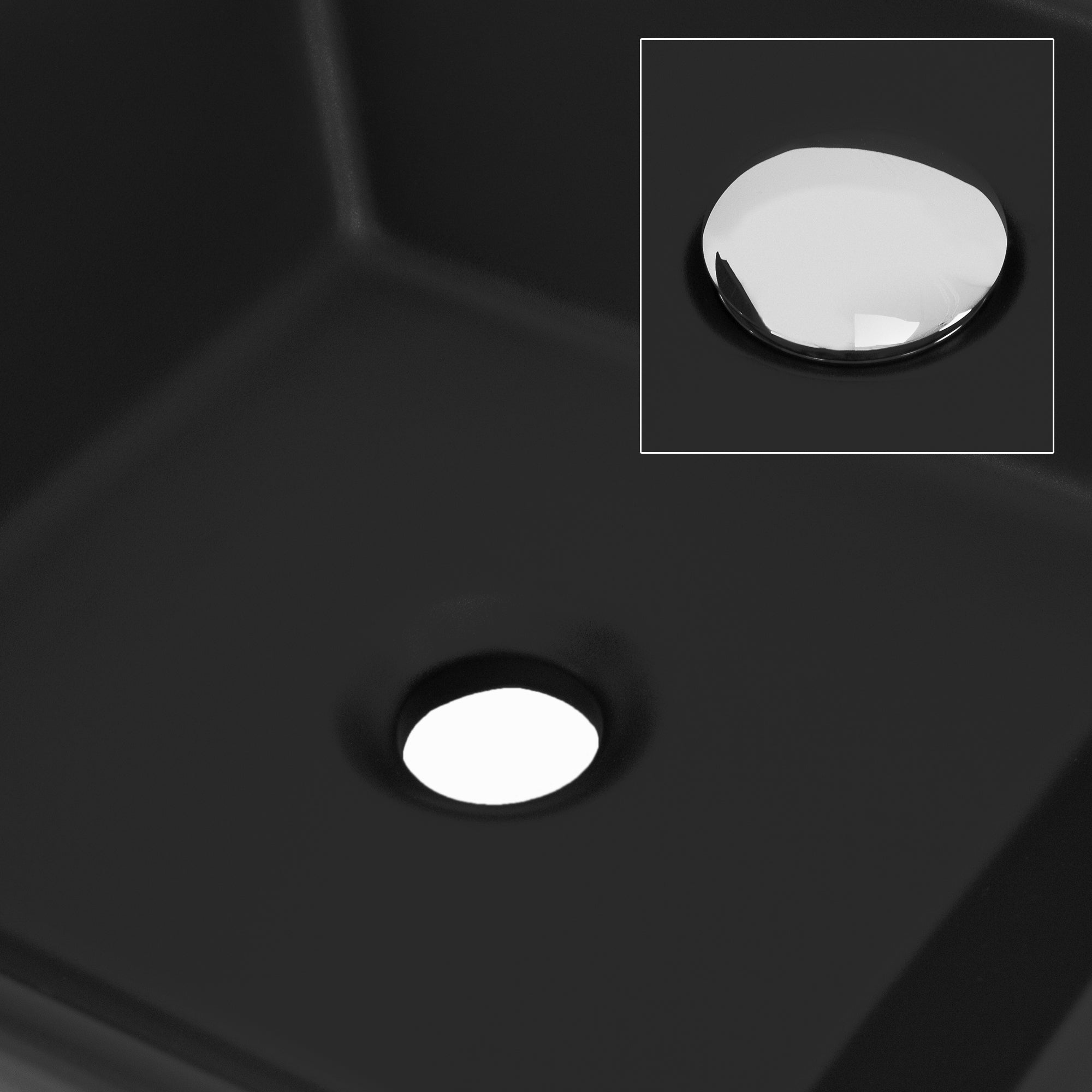 Primer plano de un lavabo negro con desagüe de agua y gotas de agua.